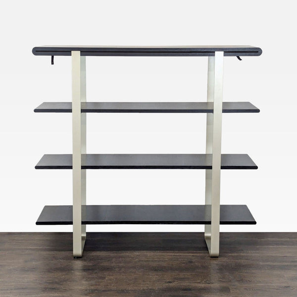 A modern bookshelf with four black wooden shelves and a sleek metal frame, ideal for displaying books or decor.