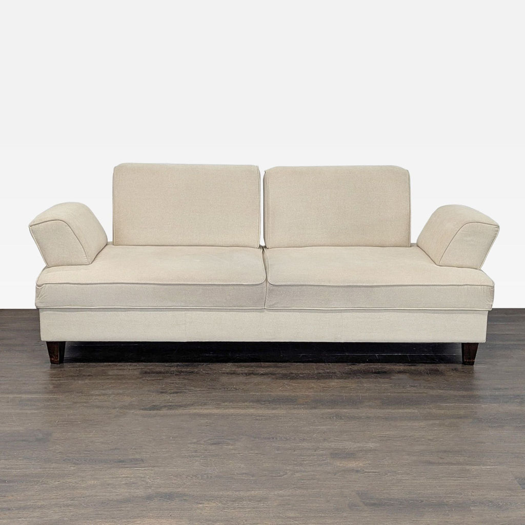 Beige Shermag Canada 3-seat sofa with modern design, plush cushions, wooden legs, and unique armrests.