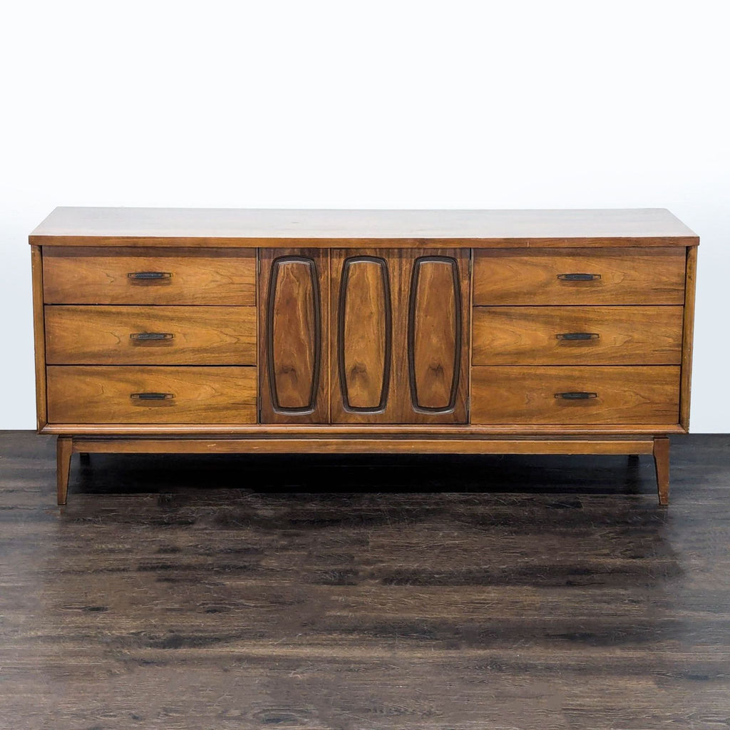 Broyhill walnut sideboard featuring metal pulls, three drawers at each end, and spacious central storage.