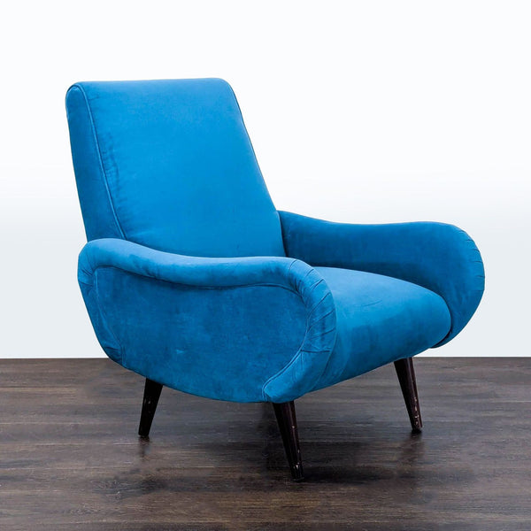 Modern lounge chair with bold blue upholstery and wooden legs from Freestyle Collection.