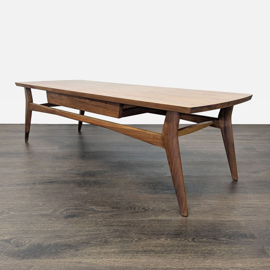 Vintage one-drawer walnut table with striking metal hardware, embodying elegant 1960s design.