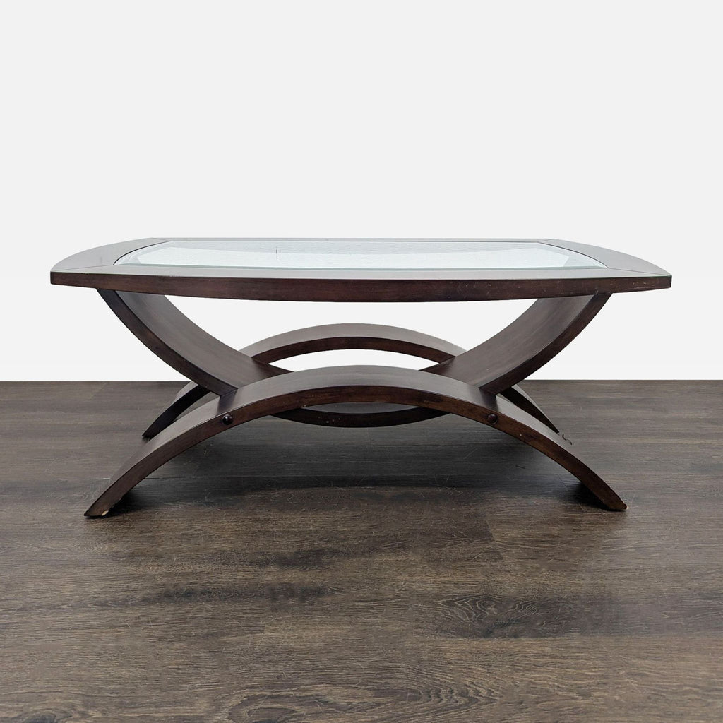 Curved-leg coffee table with a beveled glass top by Magnussen Home.  