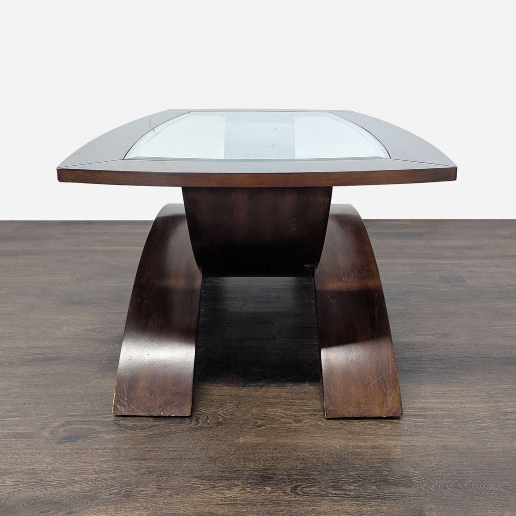 Magnussen Home coffee table featuring sleek curved legs and a glass insert.  
