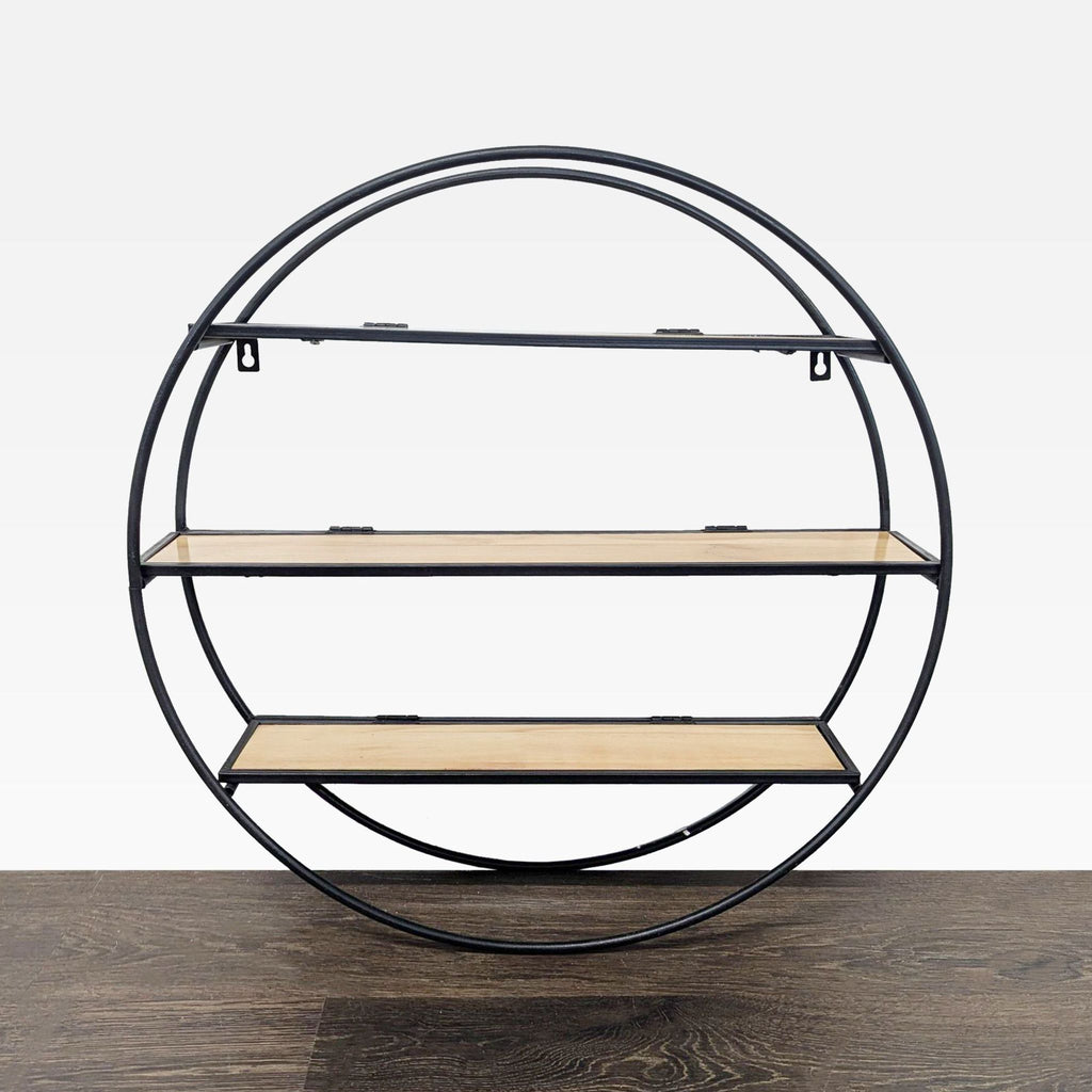 Modern round wall bookshelf with black metal frame and three wooden shelves for decor; World Market brand.
