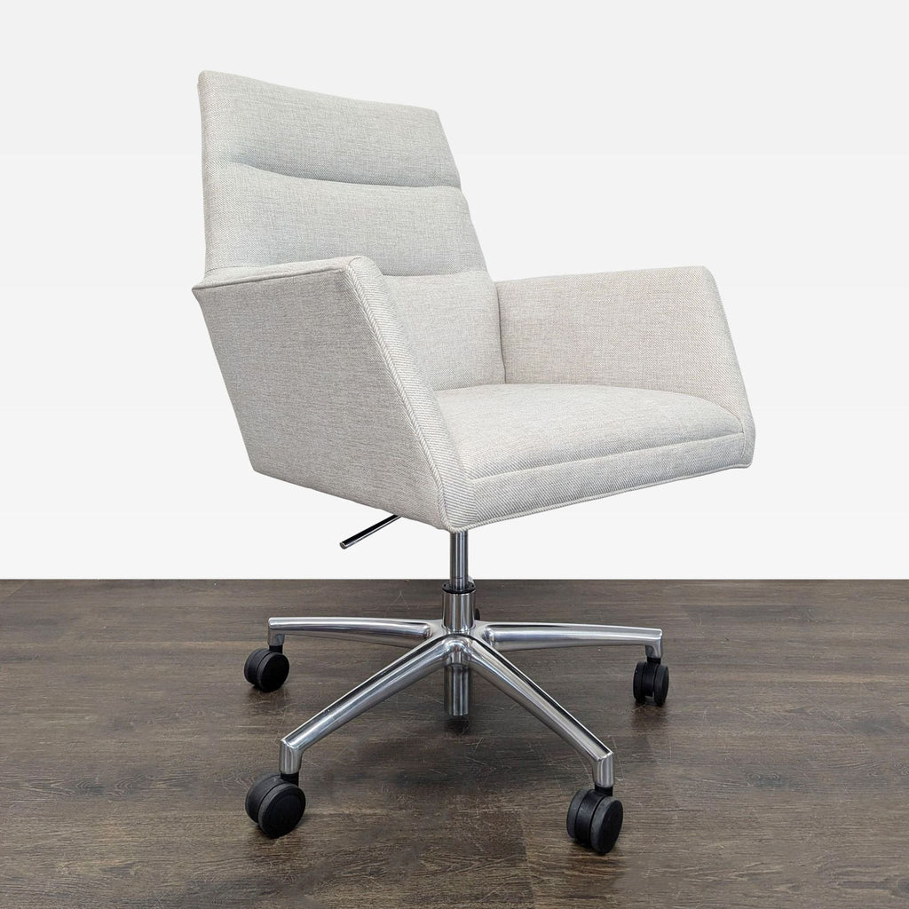 Room & Board chair featuring a sleek gray seat, supportive arms, and a sturdy chrome base with wheels.  