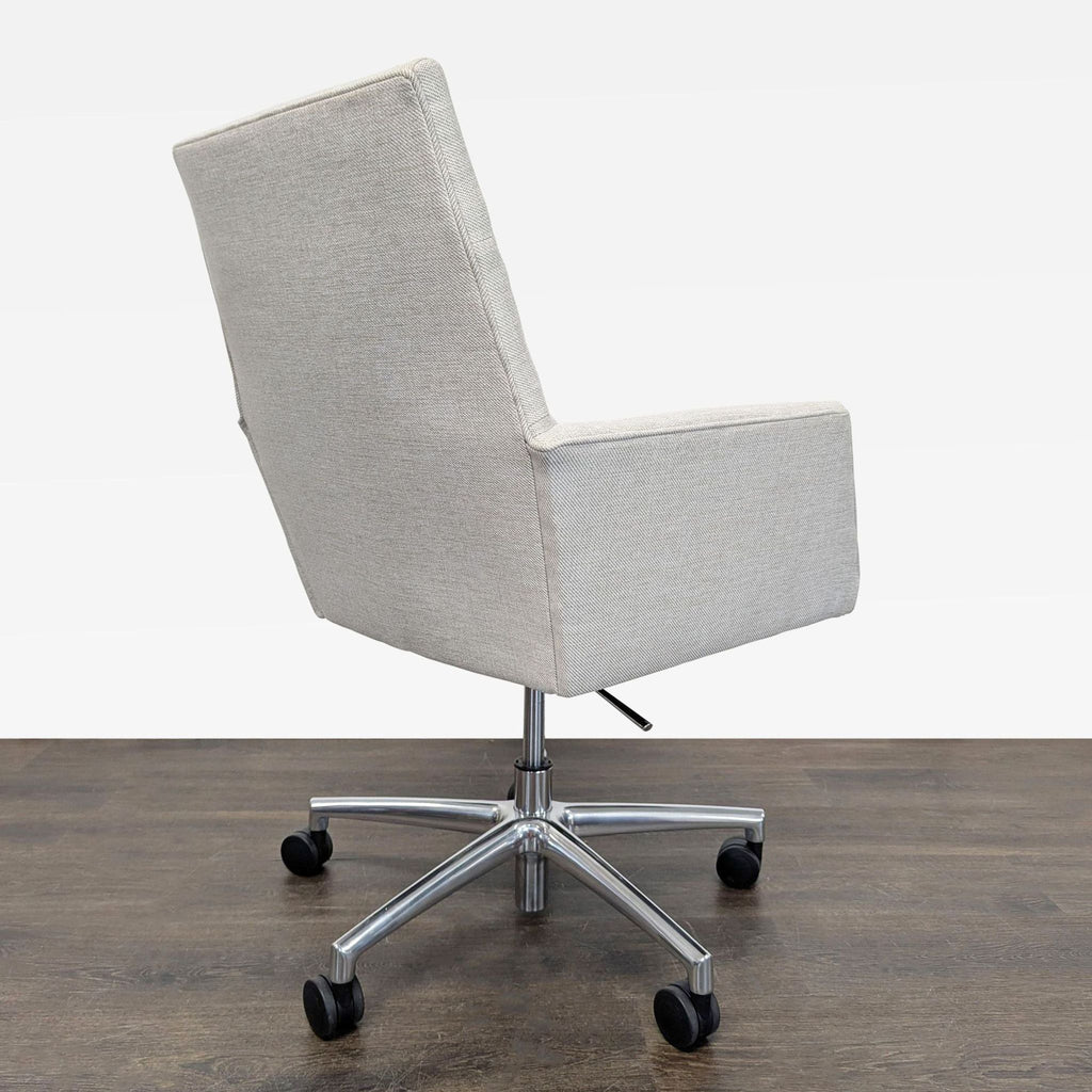 Contemporary gray upholstered office chair by Room & Board, includes casters and armrests for comfort.