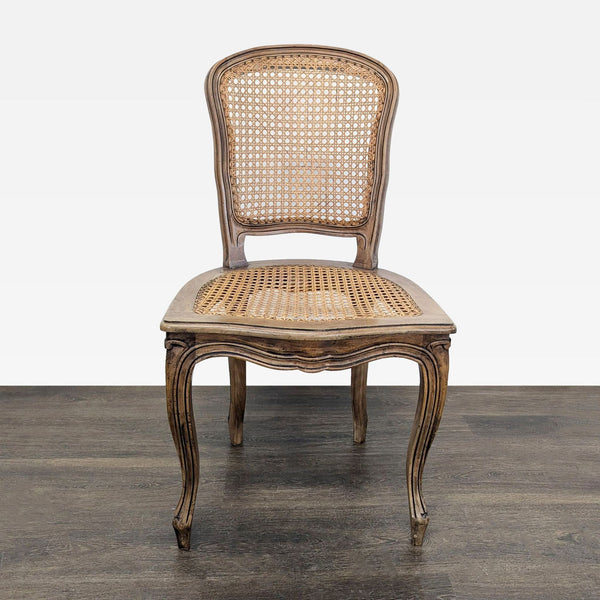 Wood dining chair with carved wood frame and woven cane back and seat.