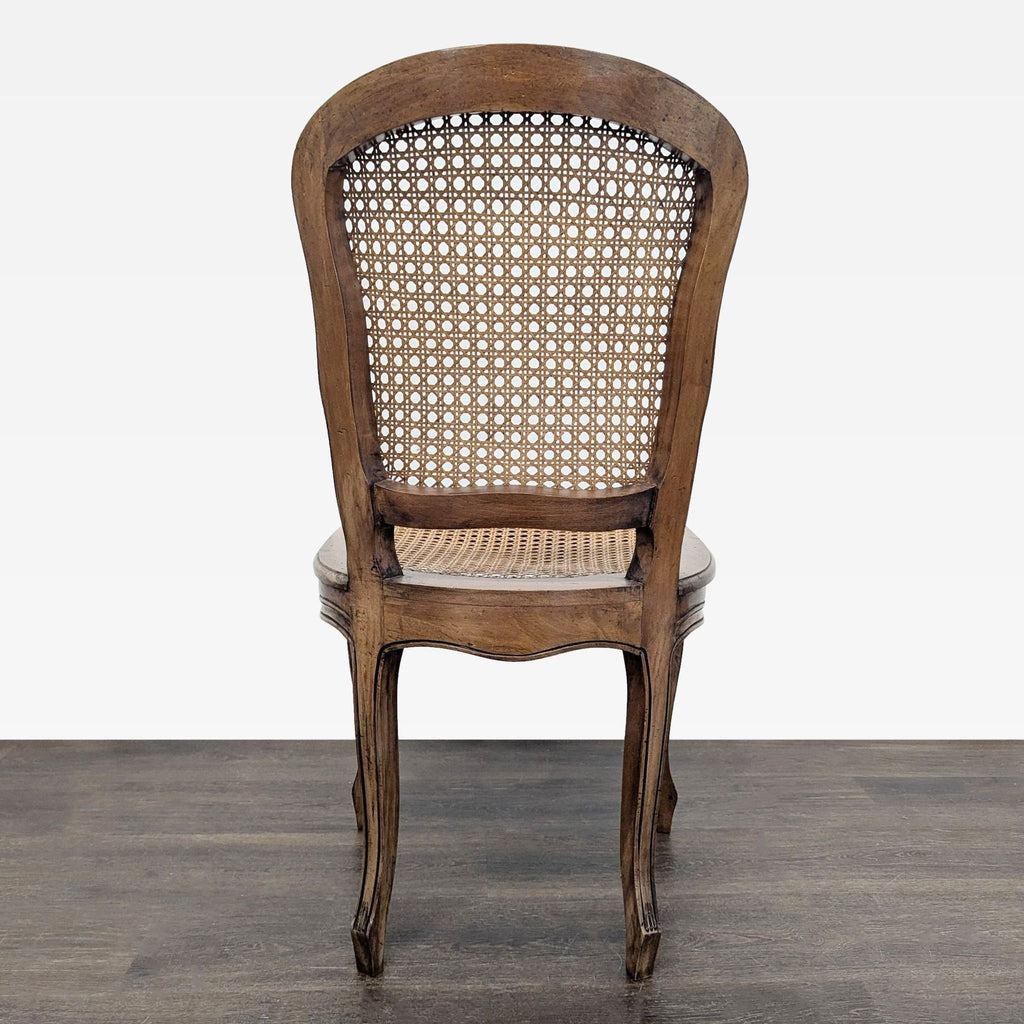 Elegant dining chair featuring a carved wood design and caned backrest and seat.  