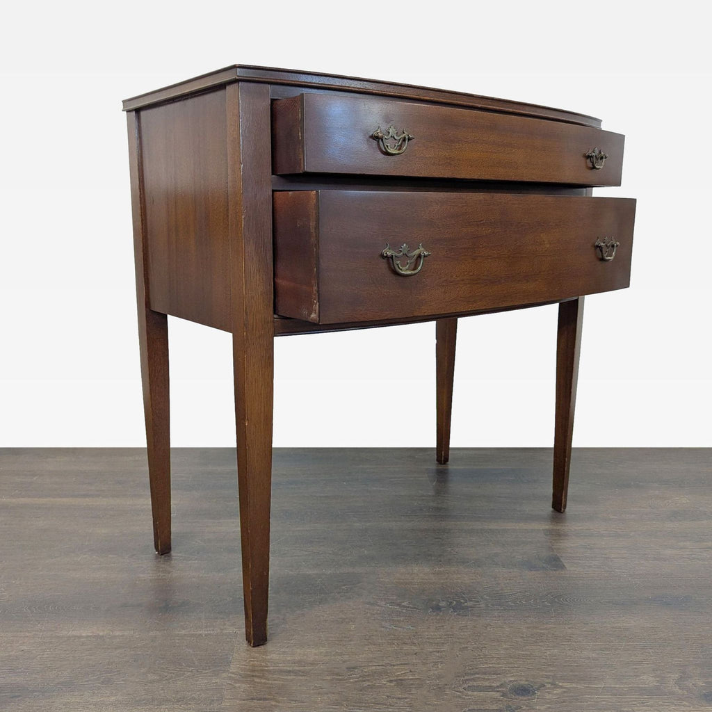 1. Vintage wooden side table with two drawers, tapered legs, and ornate metal handles, shown from the front.