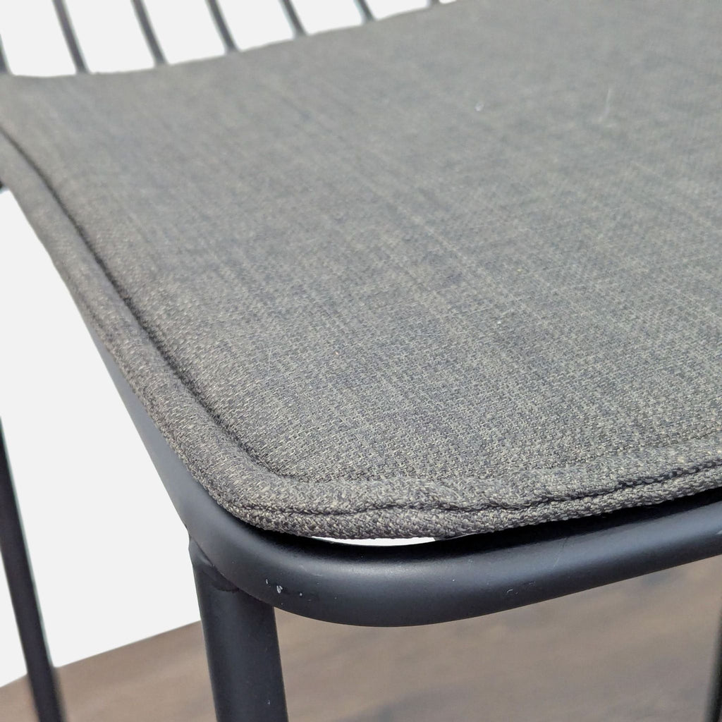 2. Modern Project 62 stool featuring a black wire frame, circular seat, linen cushion, and slatted back.  