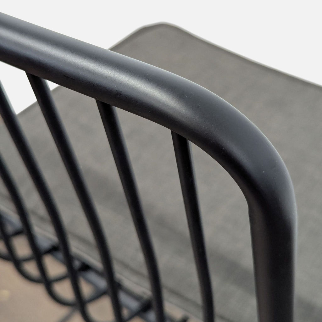 3. Project 62 stool with black steel frame, slatted backrest, round seat, and removable linen cushion.