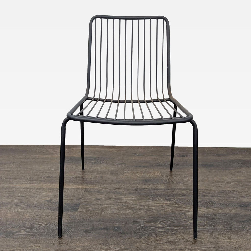 Sleek black metal wire chair with minimalist design, suitable for modern dining or office spaces.