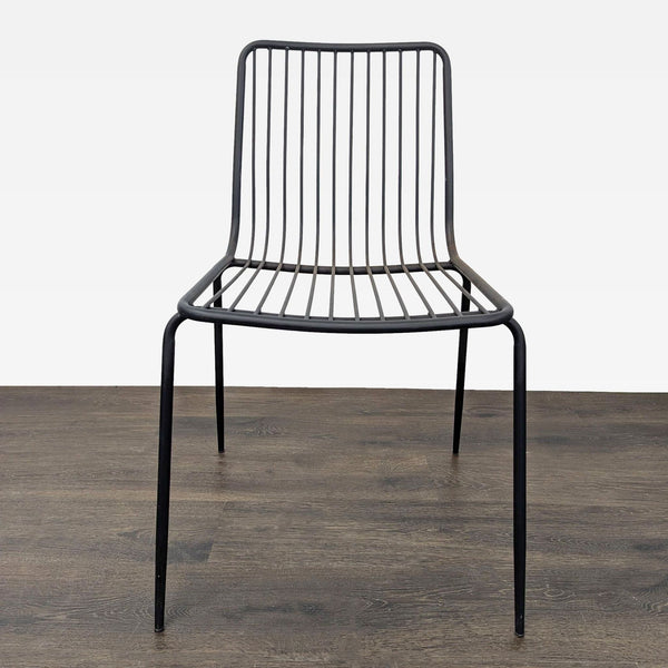 Sleek black metal wire chair with minimalist design, suitable for modern dining or office spaces.
