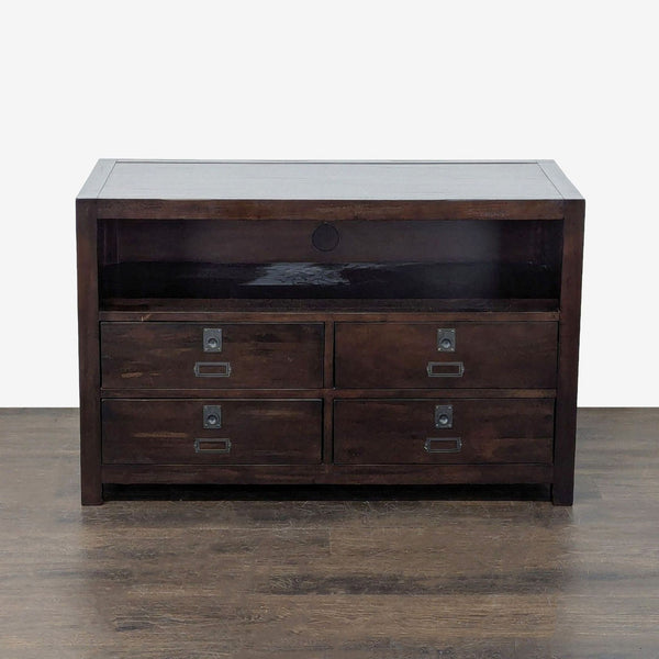 Pottery Barn entertainment center in dark wood, featuring four drawers and an open electronics shelf with cable cutout.  