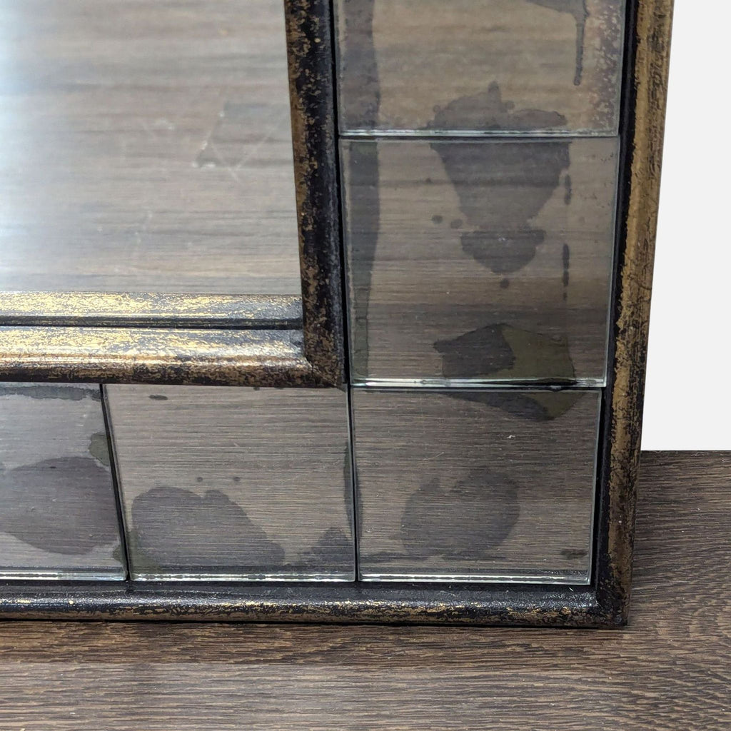 2. Close-up of the mirror’s corner, displaying antiqued mosaic tiles set into a dark wood frame.