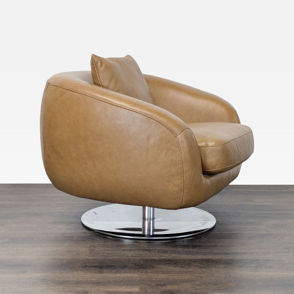 Sleek Castlery lounge chair in tan leather, features plush cushion, pillow, and contemporary chrome base.  