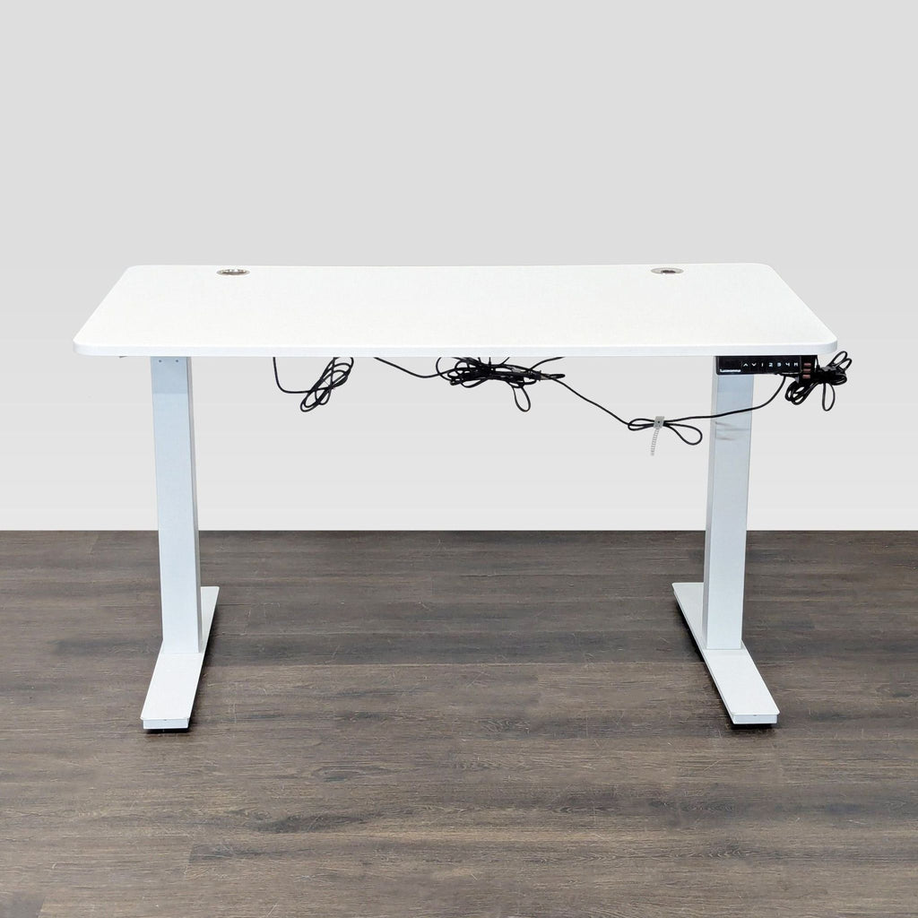 Autonomous adjustable white desk with modern design, spacious top, and built-in cable grommets for easy management.  