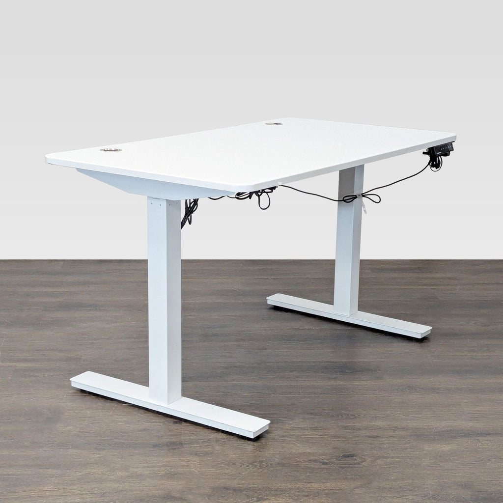 Modern white Autonomous desk with electric height adjustment, sturdy frame, and cable grommets for neat organization.  