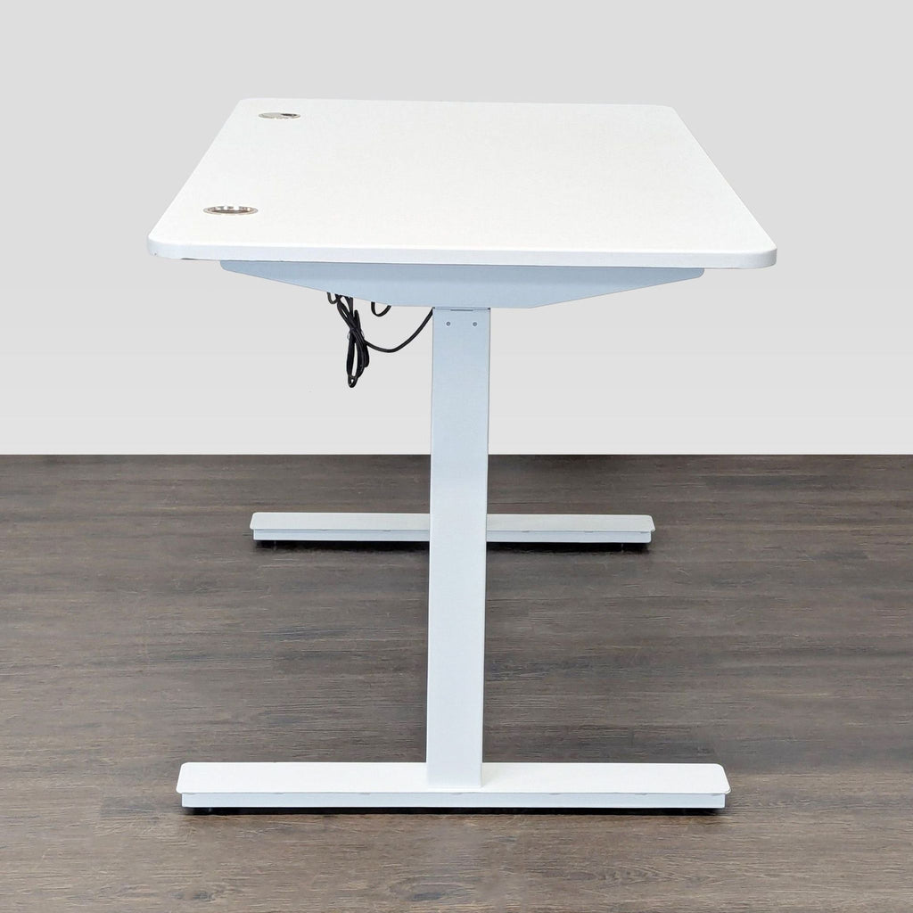 Sleek Autonomous sit-stand desk, featuring a rectangular white surface, sturdy build, and integrated cable management.