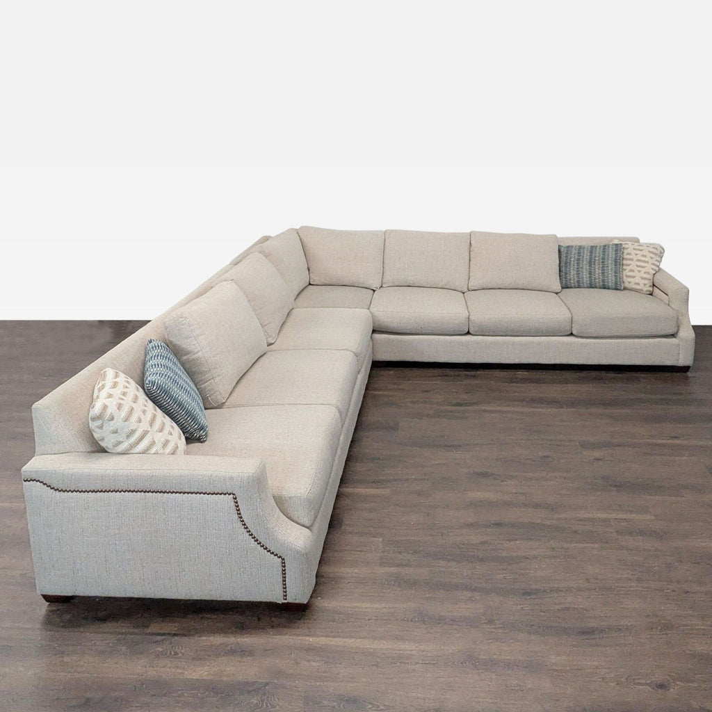 Modern sectional sofa in a neutral tone, well-maintained, part of the Baldwin Natural collection from Havertys.