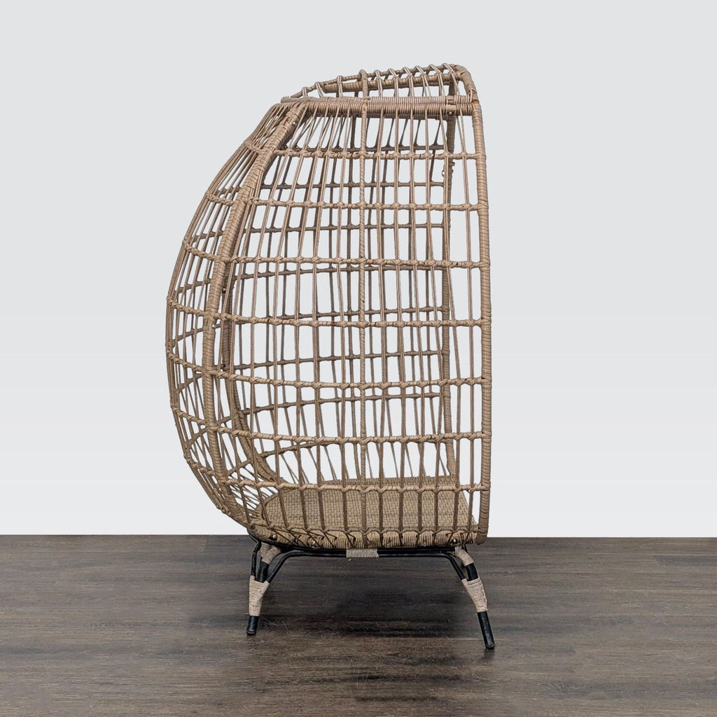 Stylish airy rattan chair featuring a rounded silhouette and sturdy black legs, perfect for any decor.