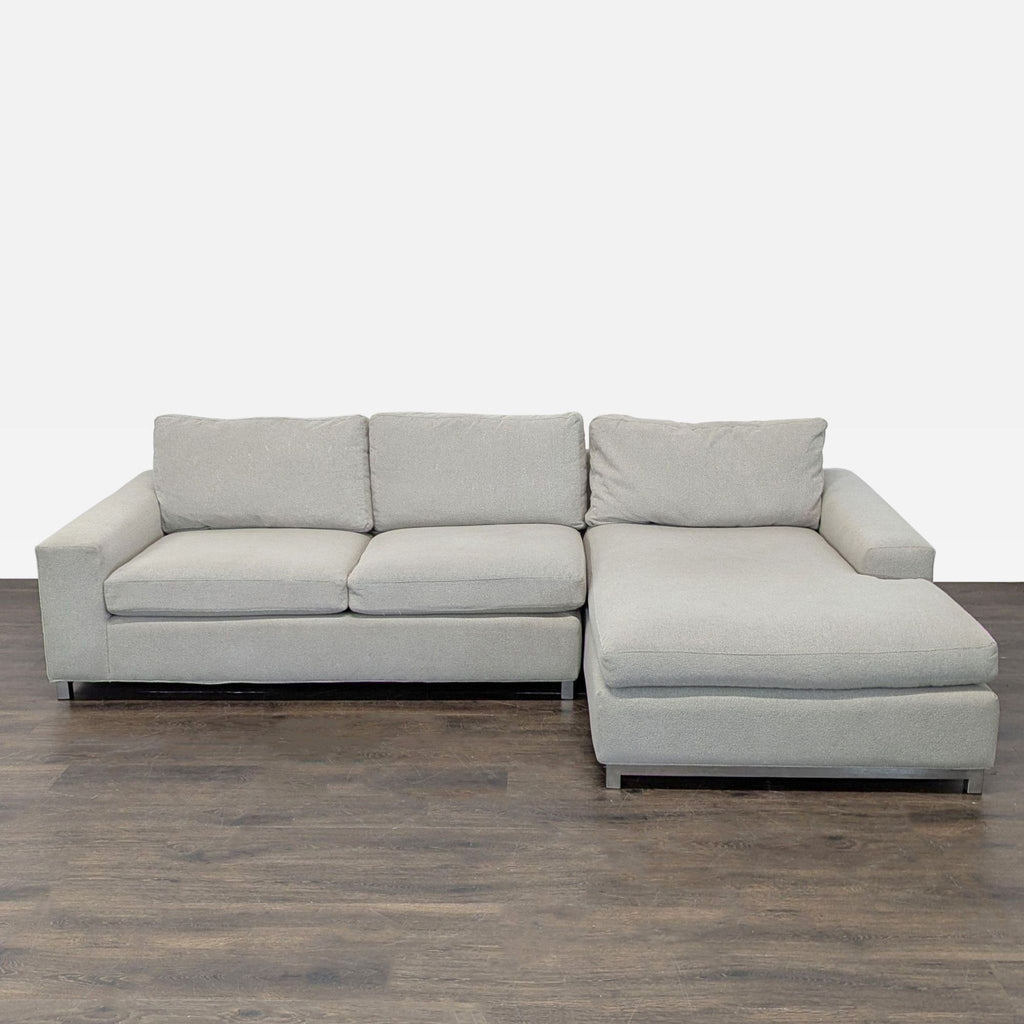 Modern Room & Board sectional with a right-facing chaise and metal legs in light neutral fabric.  
