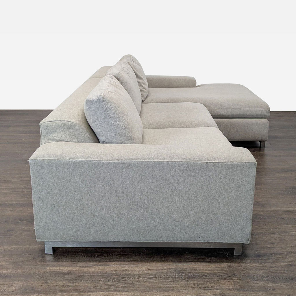 Contemporary sectional sofa, deep seats and low profile, upholstered in light fabric by Room & Board.  