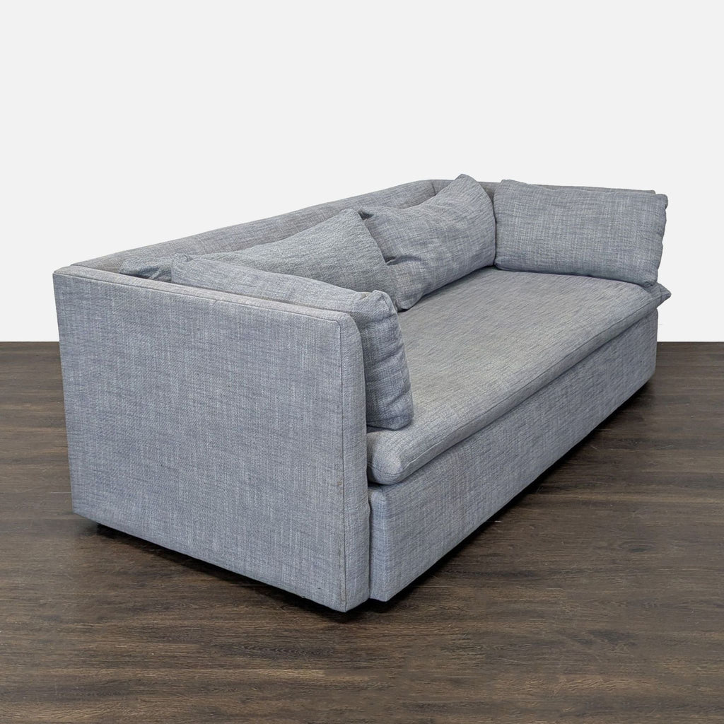 Stylish West Elm 3-seater in gray fabric, featuring loose back and side cushions, ideal for any decor.