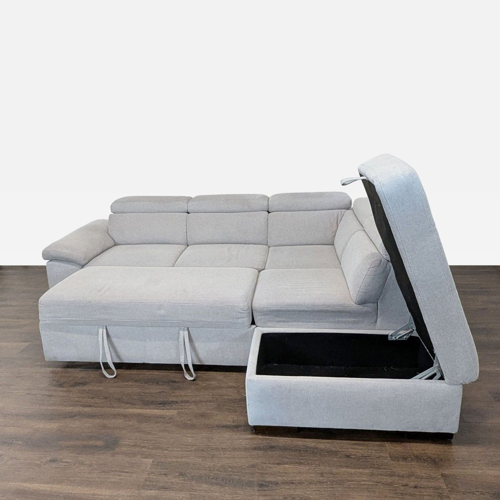Spacious sectional sofa in soft light gray fabric, featuring a storage compartment and a guest bed option.