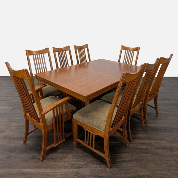 Mission-style oak dining set with trestle table, six side chairs, and two armchairs, all with slat backs.
