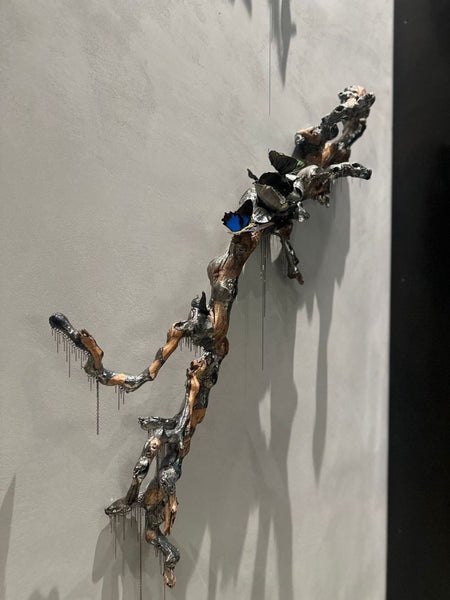 1. Closeup view of a Jocelyn Marsh wall sculpture, showing intricate textures and metallic details.  