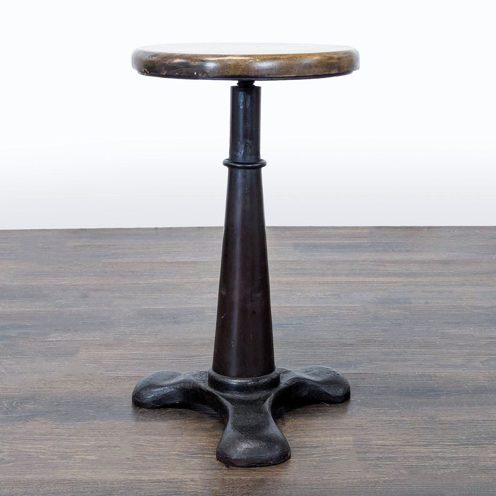 Stool with spiral stem that raises or lowers the seat when twisted.