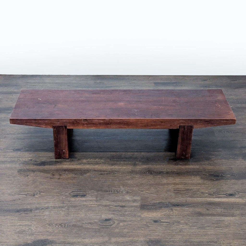 Close-up of West Elm table legs made from solid acacia wood with built-in adjustable levelers.  