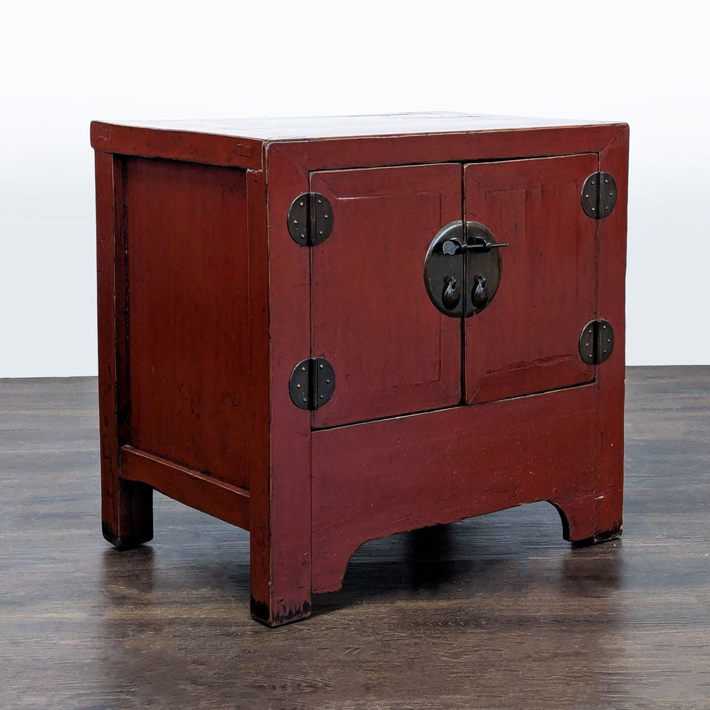 Vibrant red lacquered cabinet end table with shelving and decorative metal details.