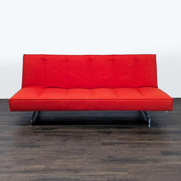 CB2 red sleeper sofa with clean lines, sturdy metal legs, and modern, space-saving design in vibrant fabric.
