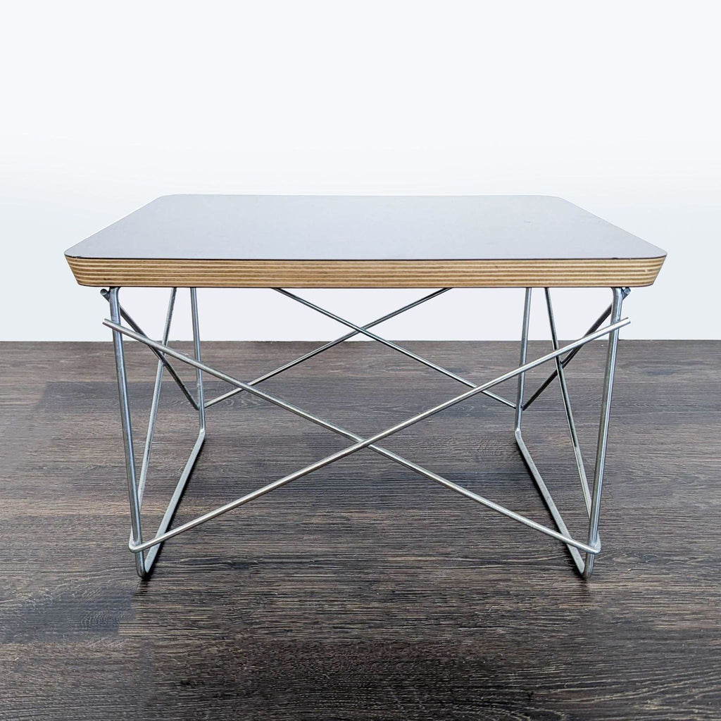 Modern end table featuring a layered birch plywood top and resistance-welded metal support by Herman Miller.  