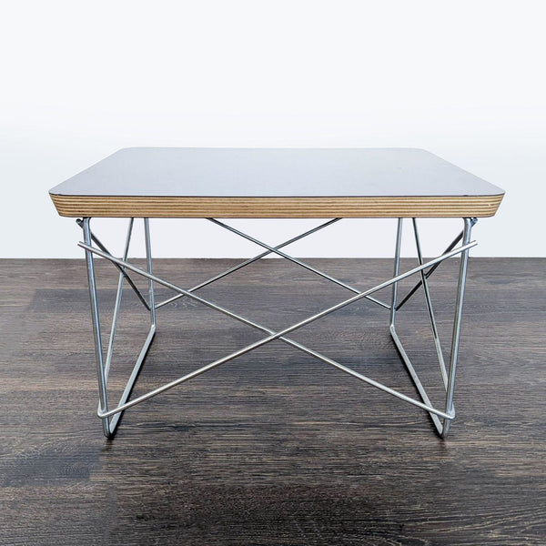 Herman Miller wooden entertainment center featuring a fold-out end table, classic and functional design.  