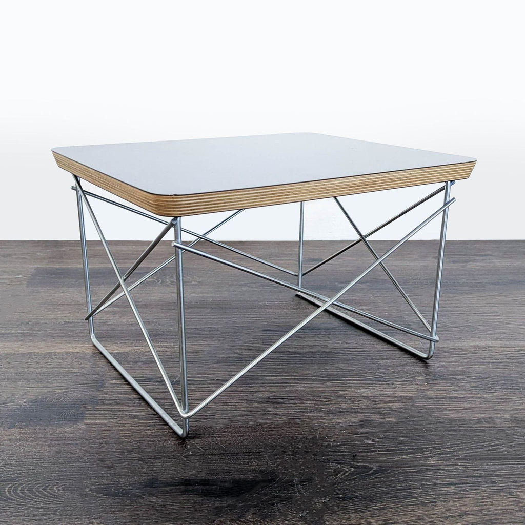 Sturdy Herman Miller end table with distinct plywood layers and robust metal bracing for enhanced support.