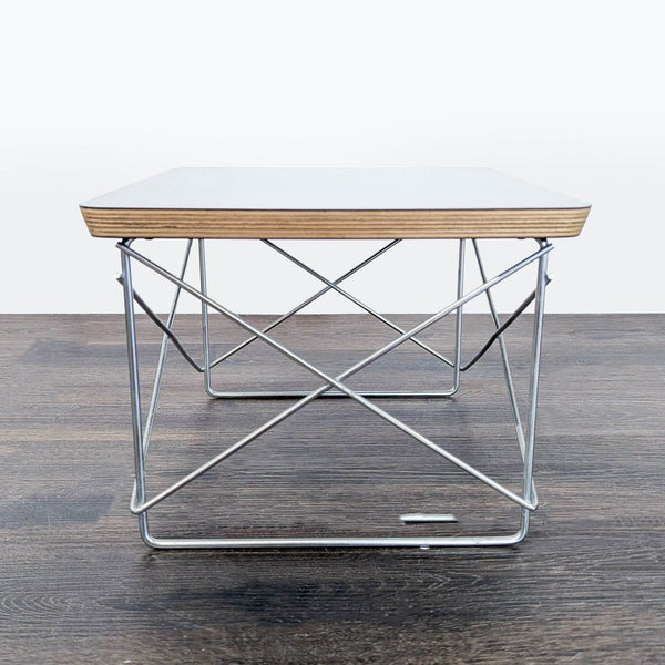 Herman Miller end table with seven-layer beveled plywood top and durable metal cross-bracing for stability.  