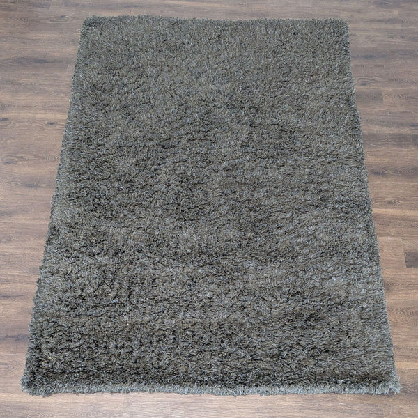 Soft, brown shaggy area rug with plush texture, ideal for cozy living spaces and easy to maintain.