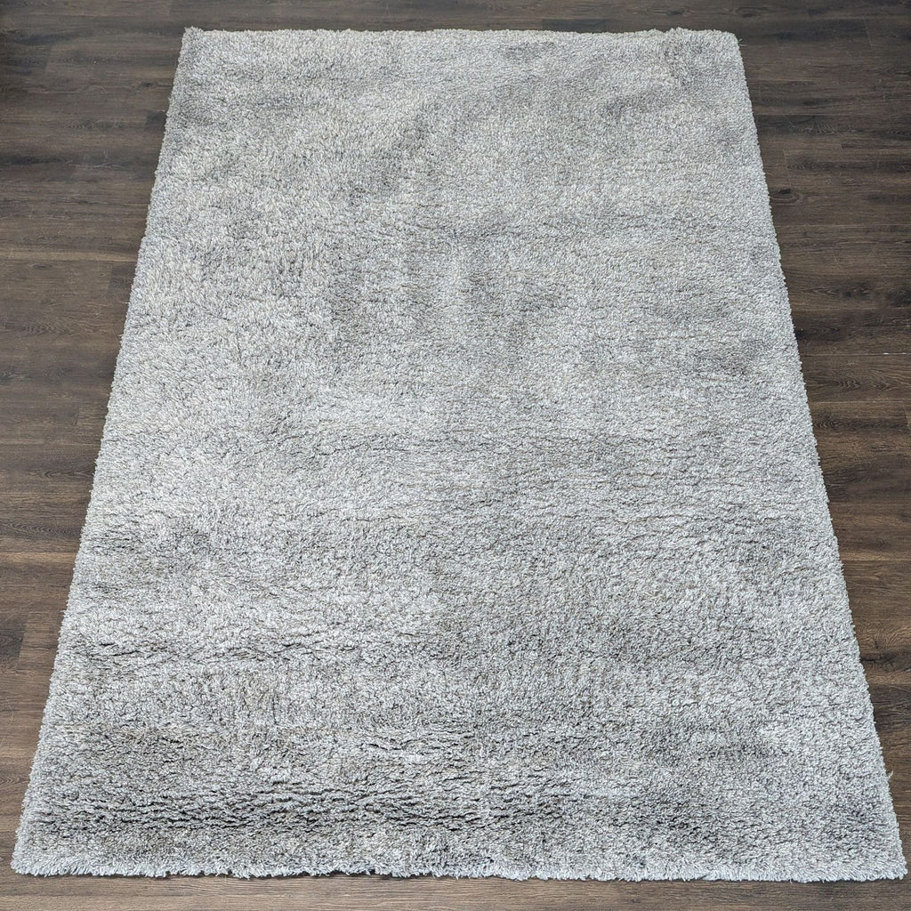 Soft gray shag rug with a thick, plush pile, adding cozy comfort to any room.  