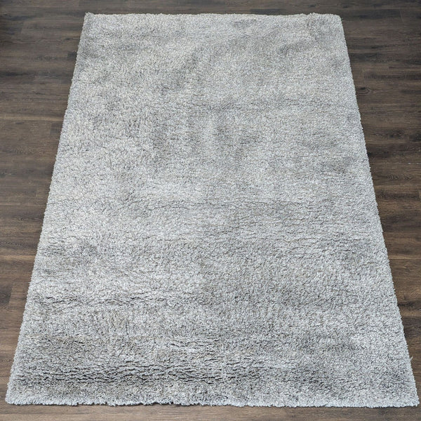 Soft gray shag rug with a thick, plush pile, adding cozy comfort to any room.  