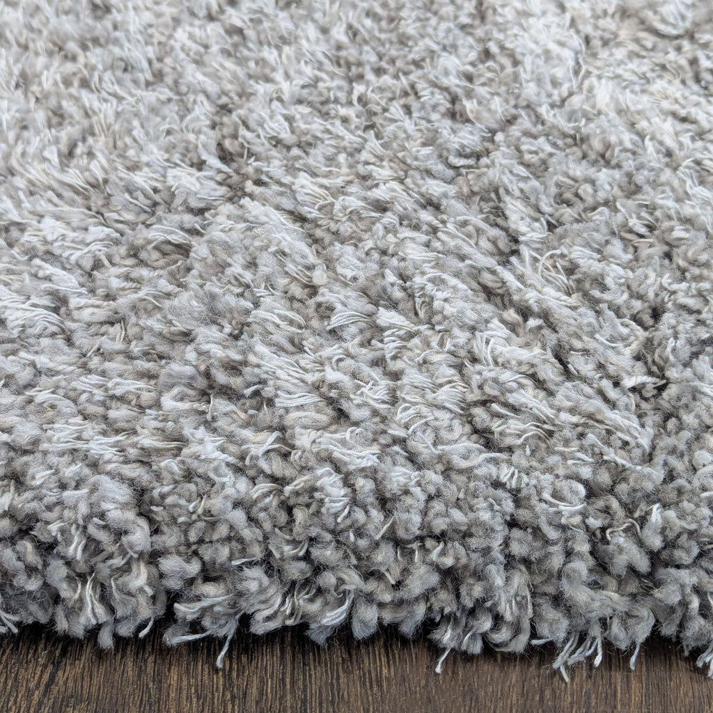 Cozy gray rug with a deep, soft texture, ideal for bedrooms, living rooms, or offices.  