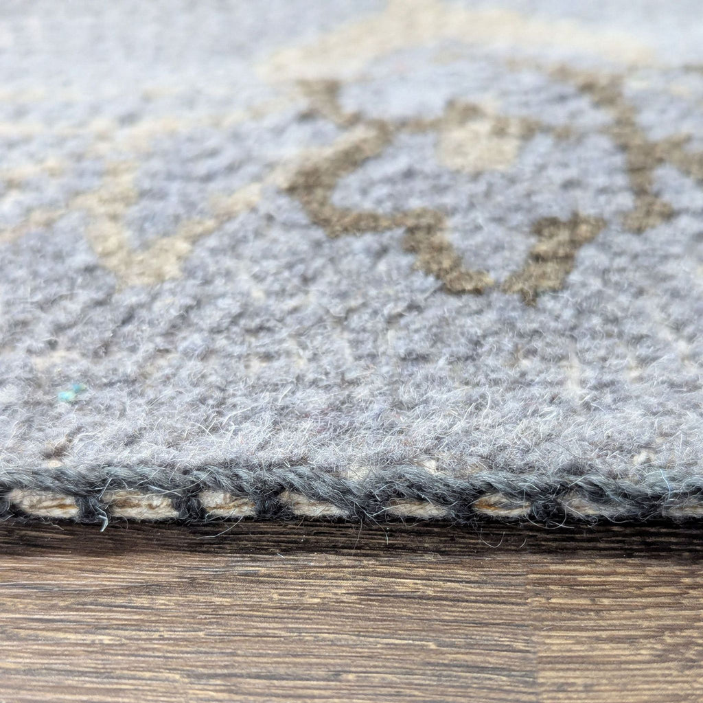 3. Side view of the West Elm rug displaying its thickness, soft texture, and neat edge stitching.