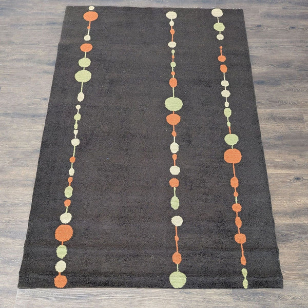 1. Modern rug with a brown base and rows of orange, green, and cream circles, perfect for stylish interiors.