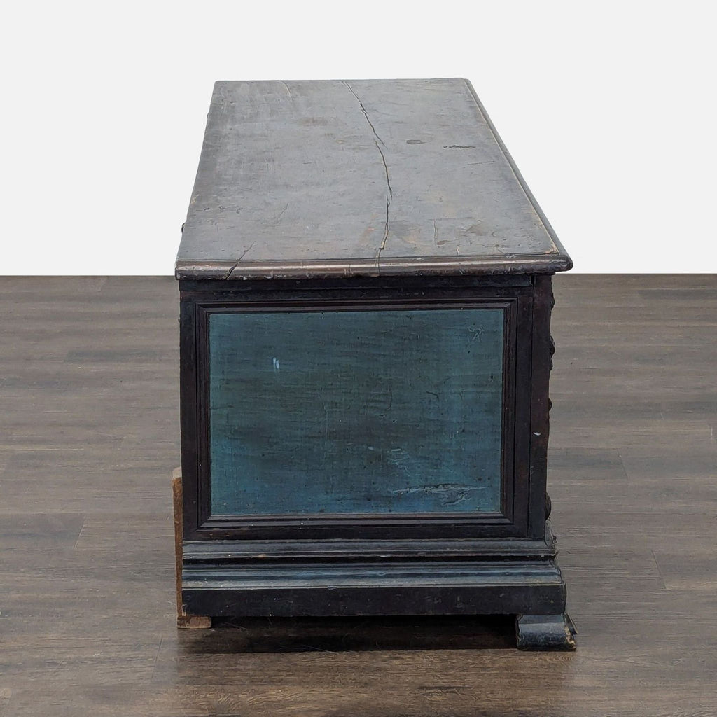 Item featuring ornate body carvings, figurative corner scenes, and intact metal hardware for hinging.