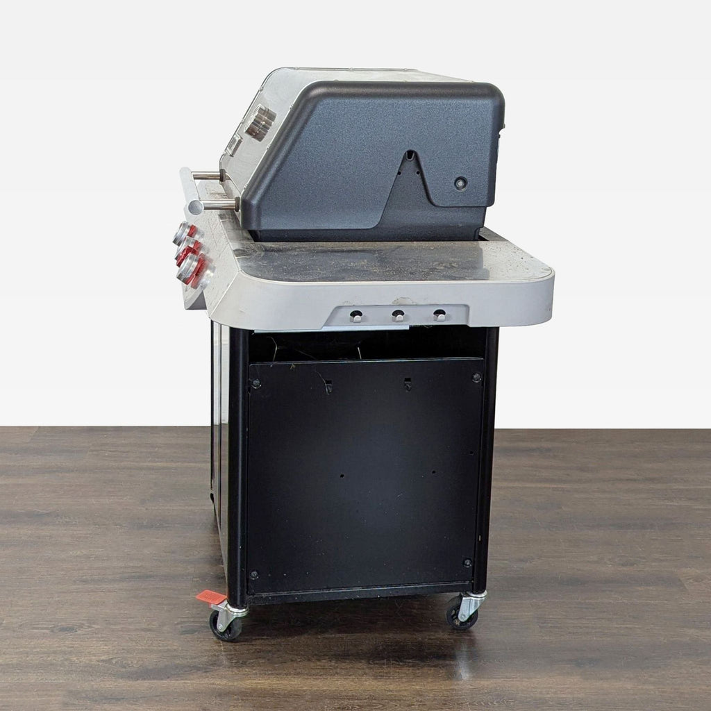 Stainless steel Weber grill on wheels with spacious cooking area, ideal for backyard barbecues and outdoor meals.