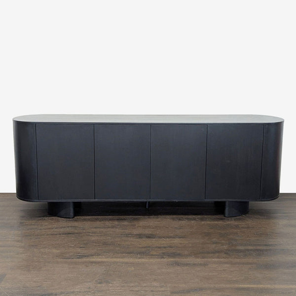 1. A solid oak sideboard by Four Hands with an aged black finish, four doors, and chunky Brutalist-inspired legs.