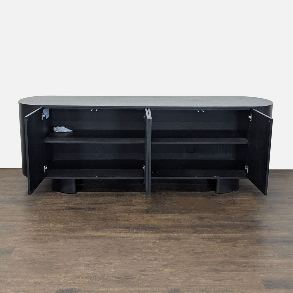 Aged black sideboard made of solid oak, featuring natural grain, four doors, and built-in cable management.