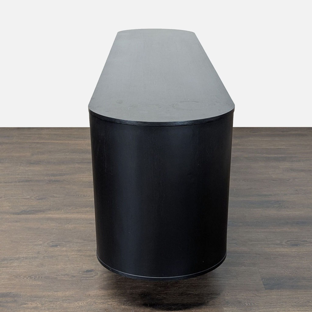 Four Hands solid oak sideboard in black finish with grain detail, adjustable interior, and bold, sturdy legs.